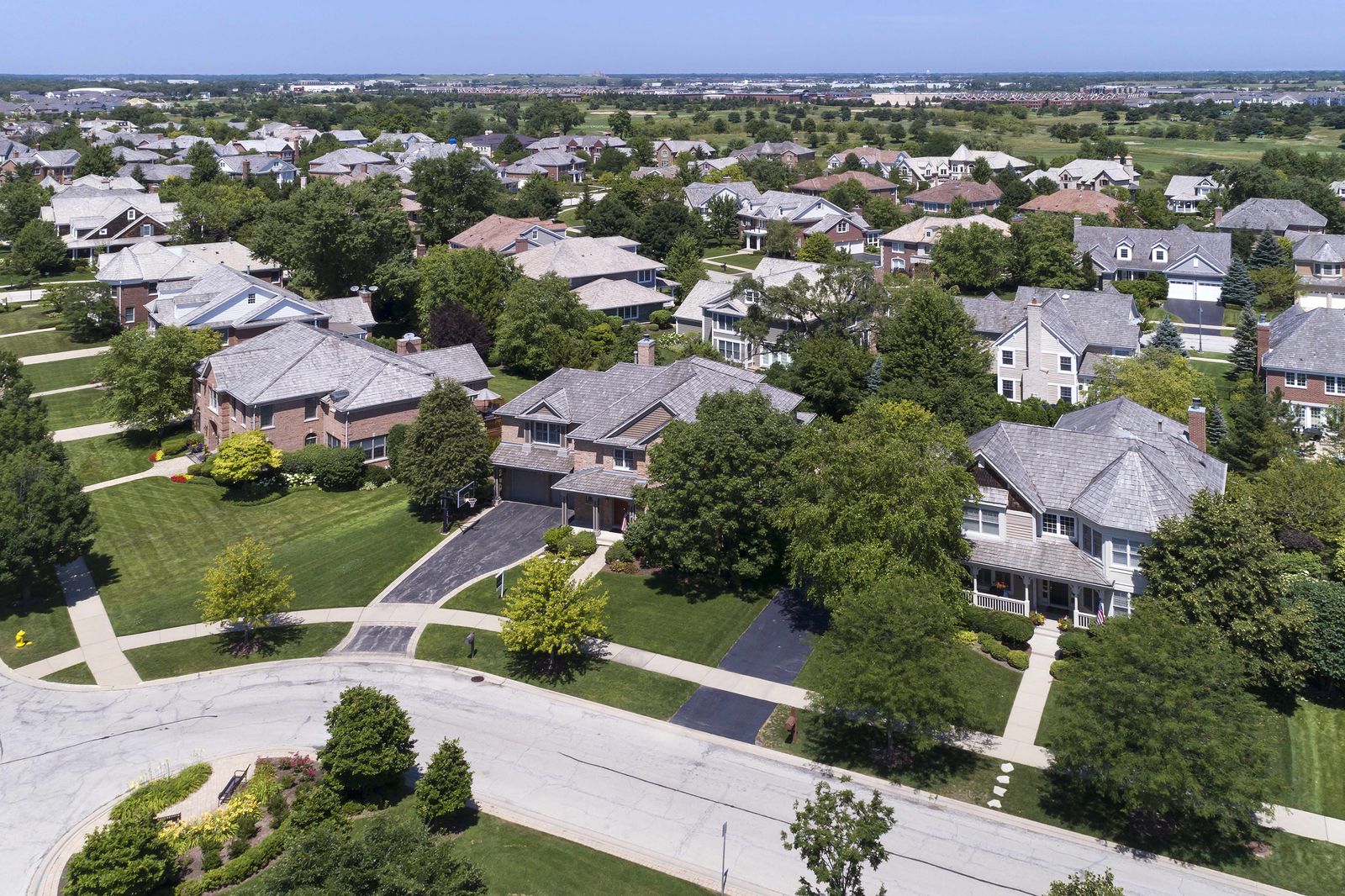 Aerial view of a block of single-family homes with new shingle roofs